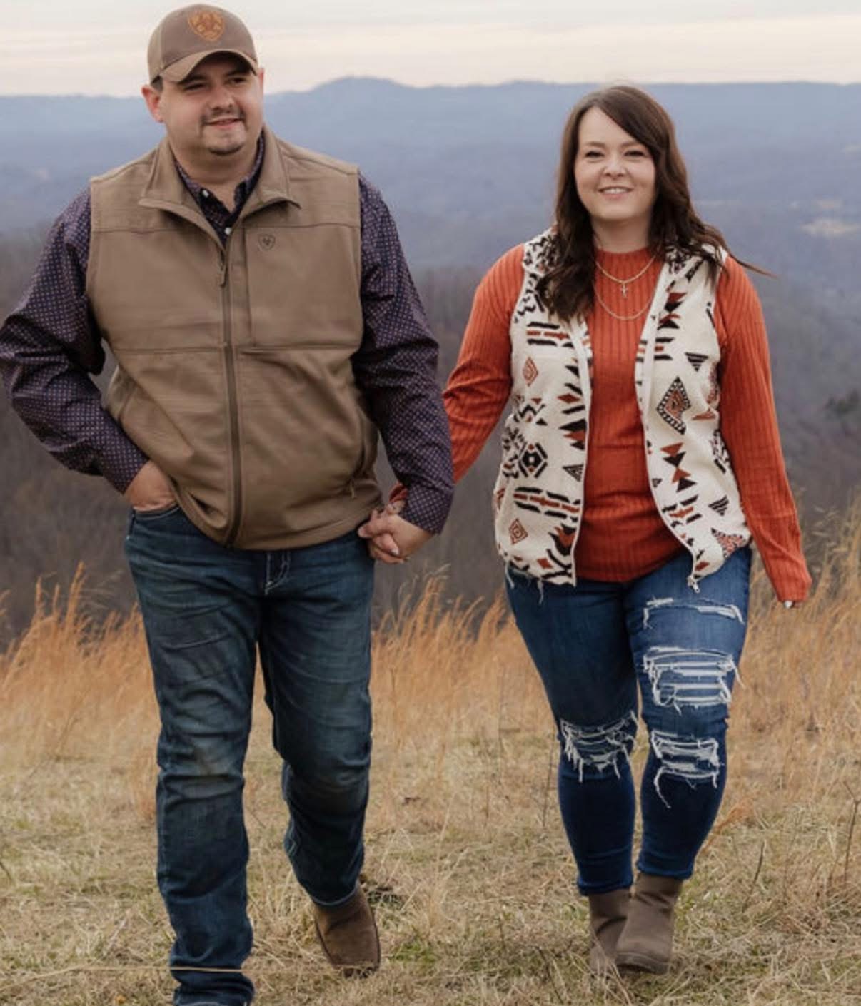 Dixie and her husband walking together in the mountains