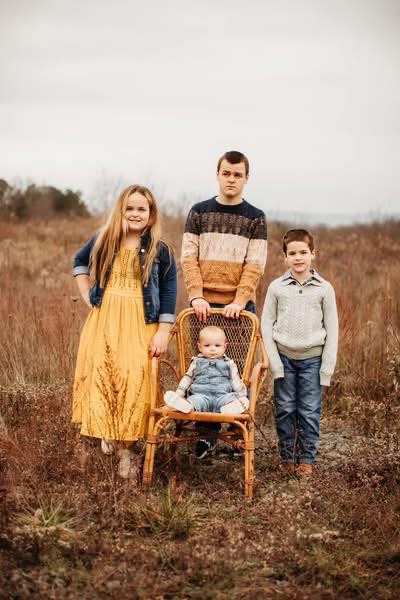 Dixie&rsquo;s four children posing in a field
